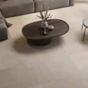 Image of a living room, focused on Ashlee Clay Stone Floor Tile, room has sofa and coffee table