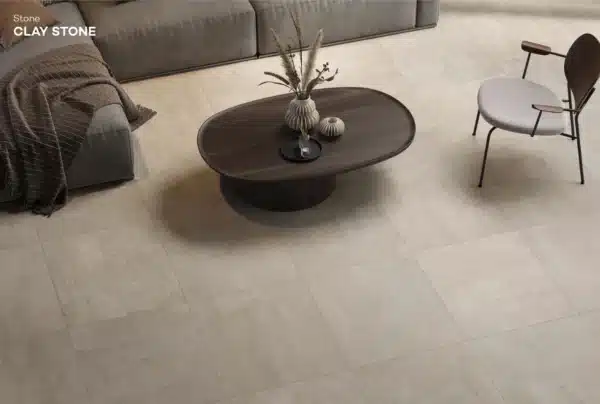 Image of a living room, focused on Ashlee Clay Stone Floor Tile, room has sofa and coffee table
