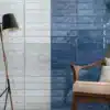 closeup of a chair, standing lamp and Marakkesh wall tiles by Ashlee behind on the wall