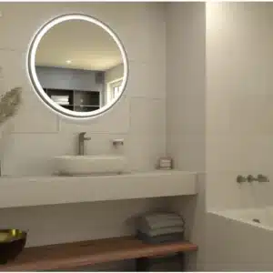 Image of bathroom, a round mirror on wall, highlighting Opificio Wall Tile by Ashlee