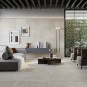 A modern living room with elegant sitting, with a Rapolano Marble Wall & Floor Tiles.