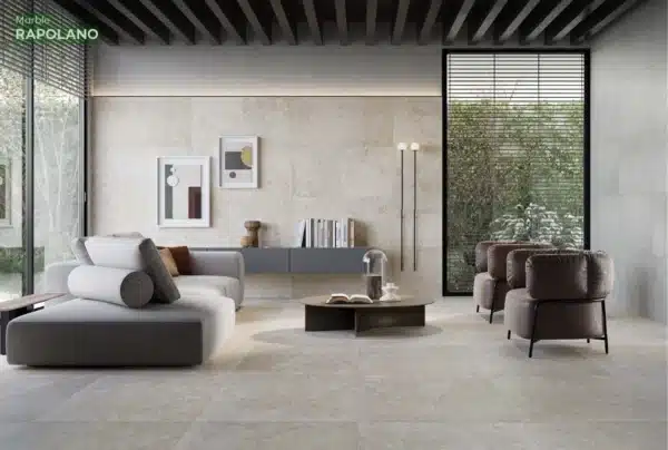 A modern living room with elegant sitting, with a Rapolano Marble Wall & Floor Tiles.