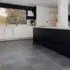 A closeup image of kitchen , showing floor made of Surface Versatile Floor & Wall Tiles