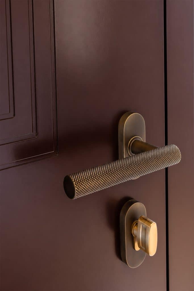 Close up of an embossed alumunium, gold effect door handle